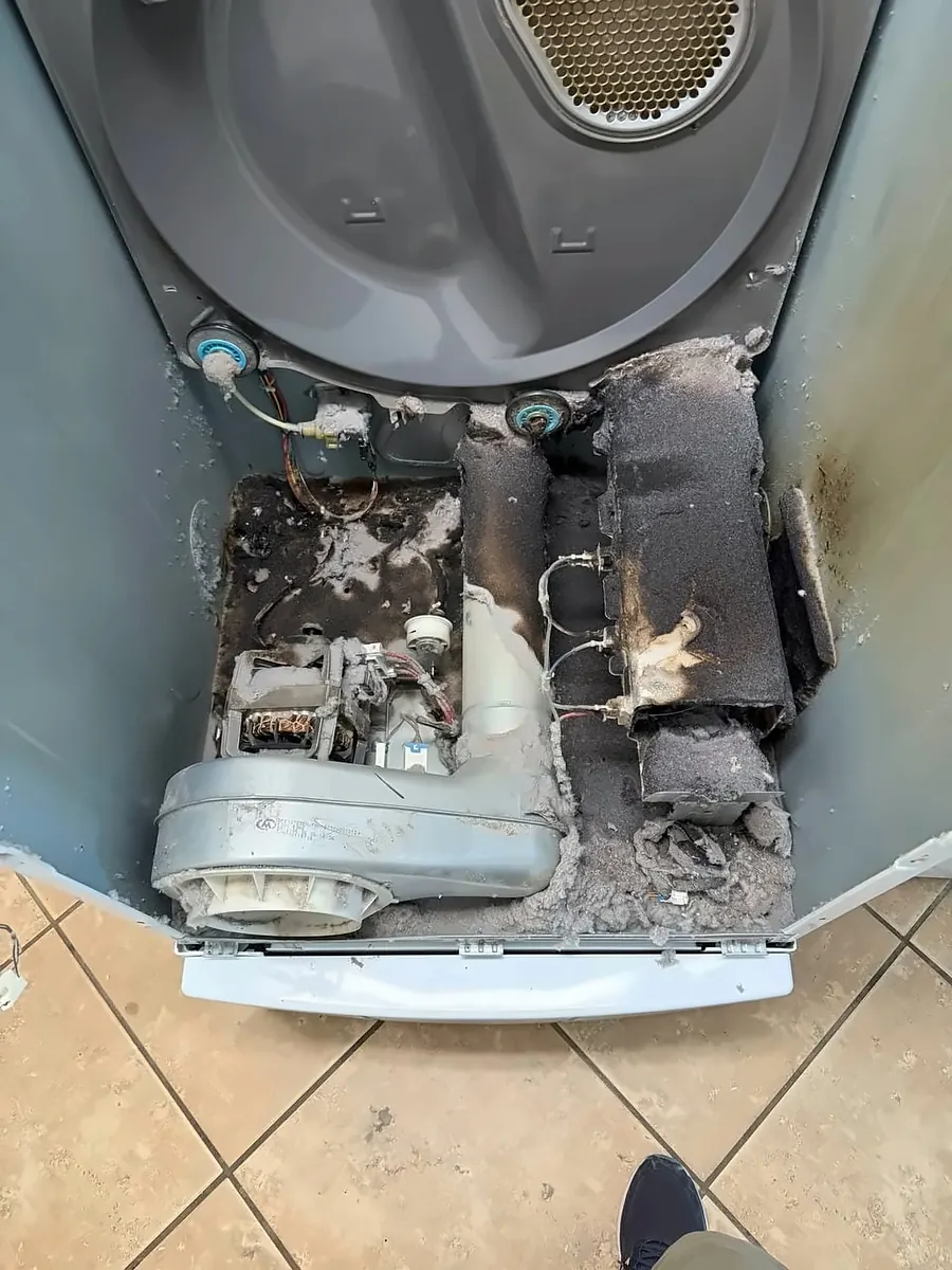Dryer cabinet packed with lint before cleaning
